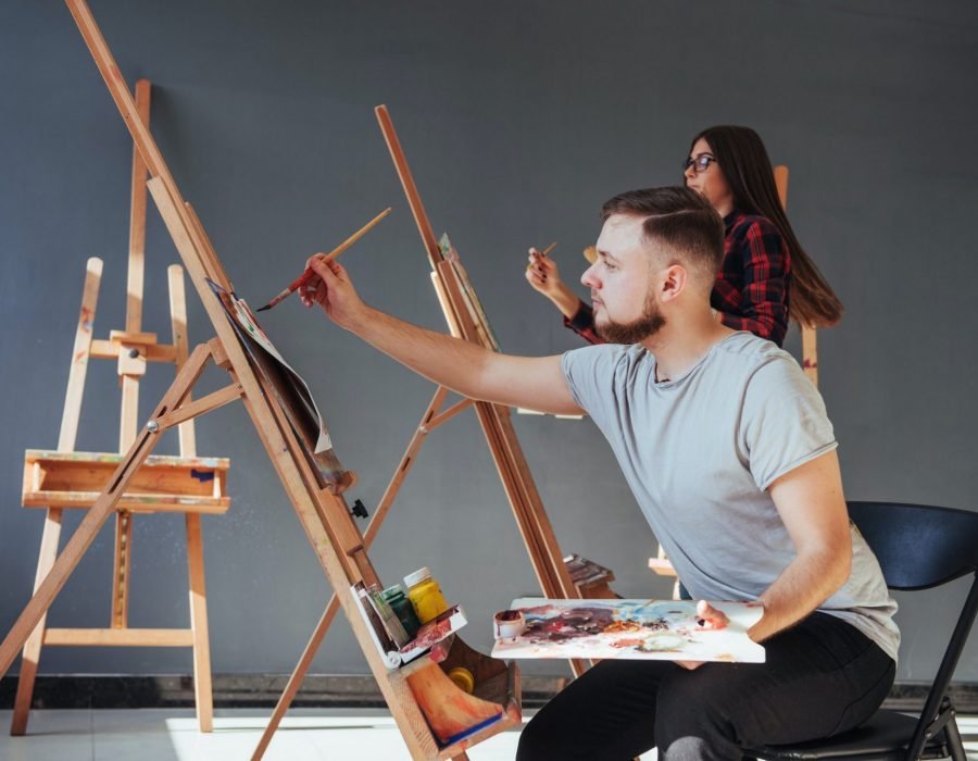 Group of students painting at art lessons